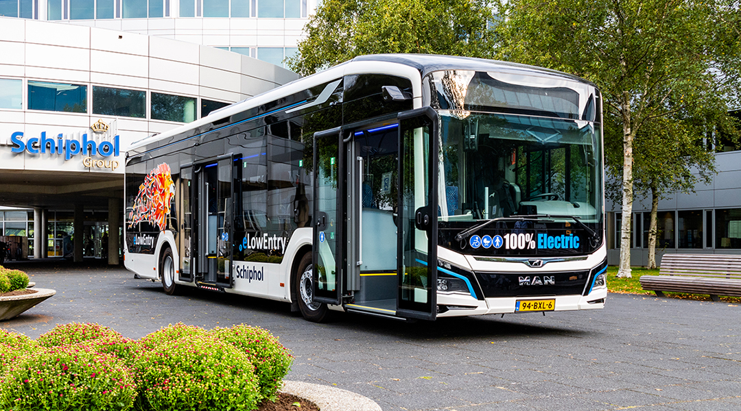 Ein Elektrobus steht vor einem Gebäude.