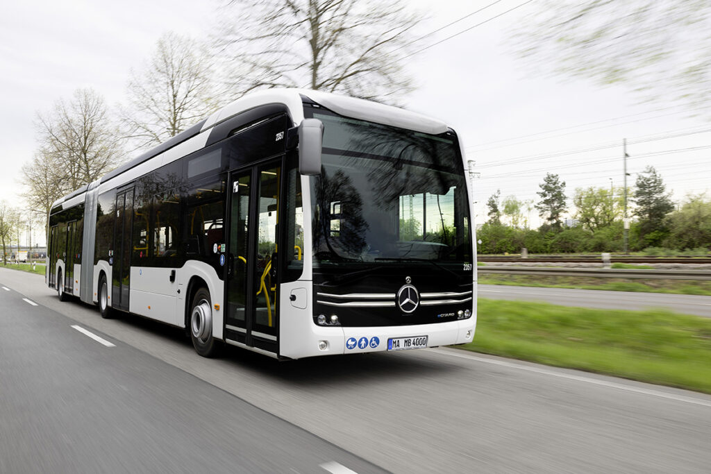 Ein elektrischer Gelenkbus des Typs eCitaro fährt auf einer Straße.