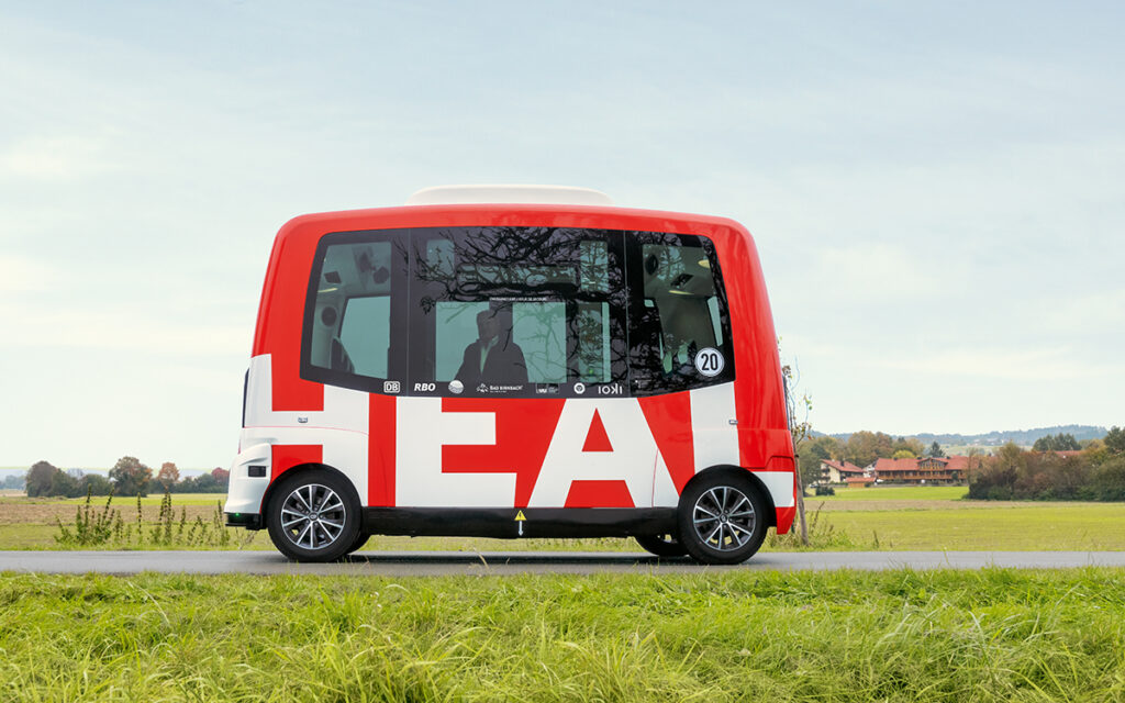 Ein Shuttle fährt auf einer Straße.