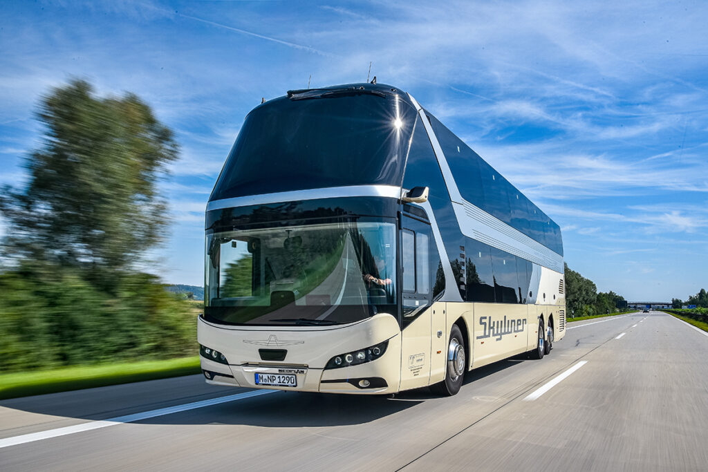 Ein Doppeldecker-Reisebus fährt auf einer Autobahn.