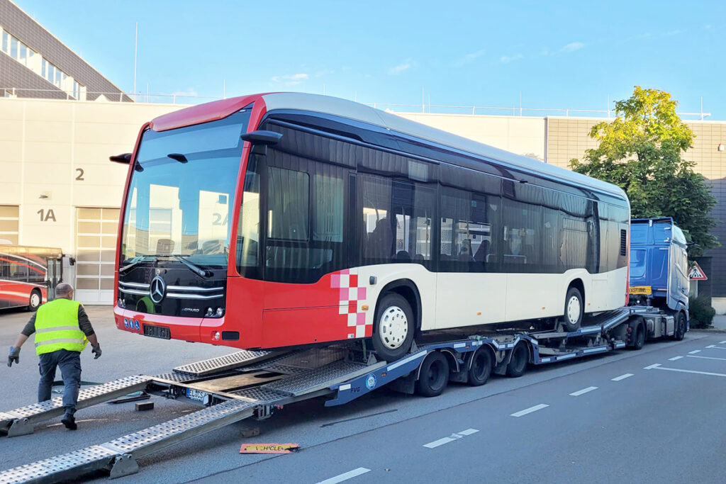 Ein Elektrobus steht auf einem LKW-Tieflader.