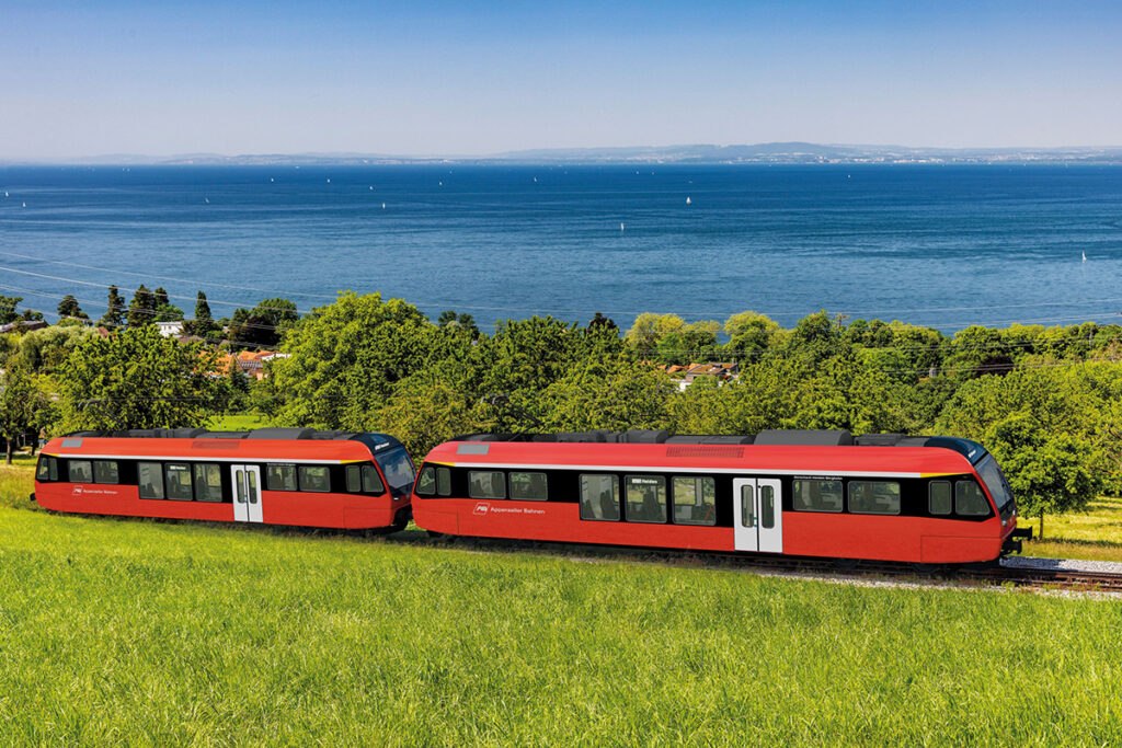 Simulation von zwei Triebwagen vor einem See.