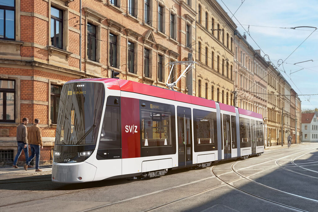 Visualisierung einer Straßenbahn auf einer Straße vor Häusern.