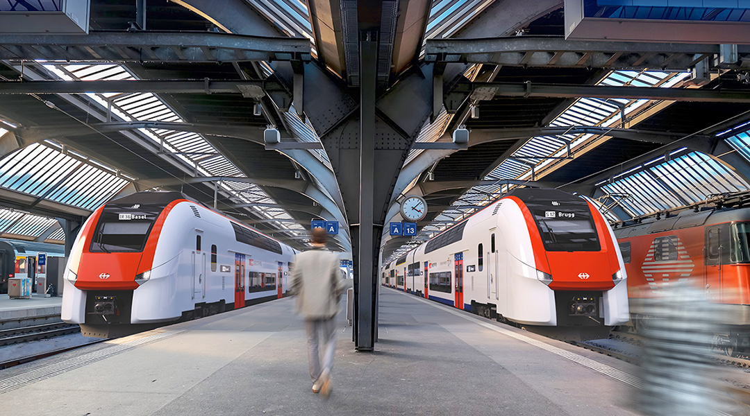 Visualisierung von zwei Doppelstockzügen in einer Bahnhofshalle.